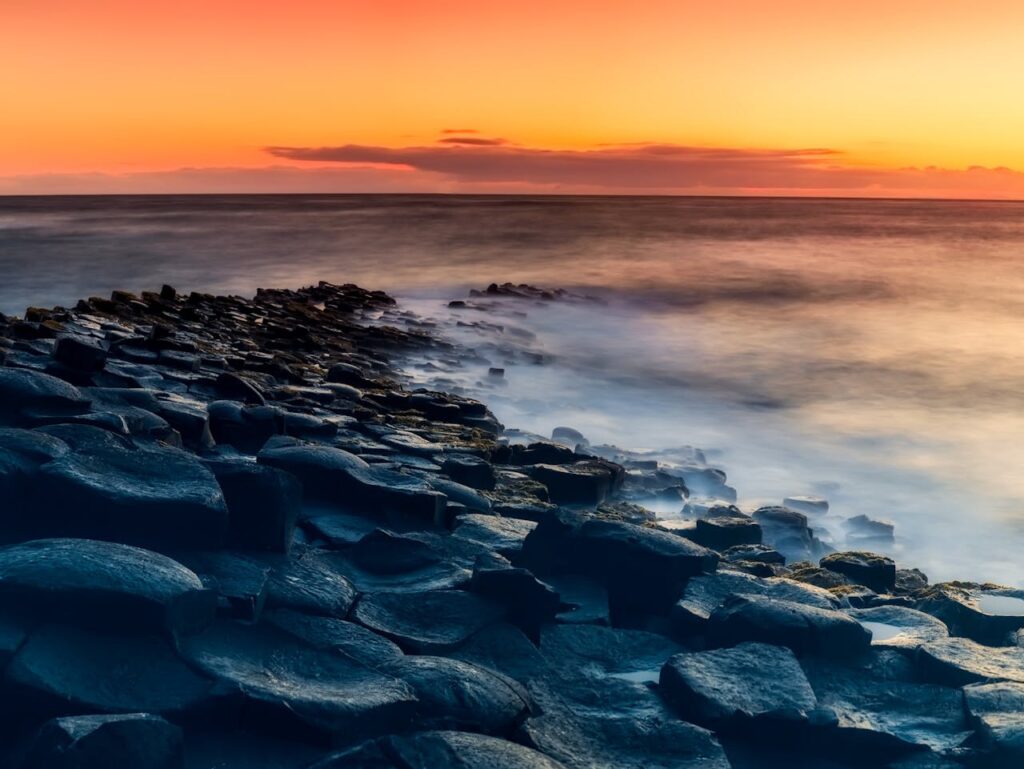 pexels-photo-533842 Enchanting sunset view over the Giant's Causeway with dramatic skies and ocean waves.